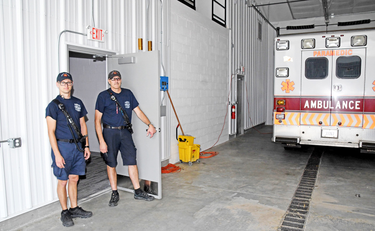 EMS Captain Brent Dethlefs, right, and crew member Chris Hyde stand in the doorway which connects the city’s new EMS living quarters to the ambulance bays.