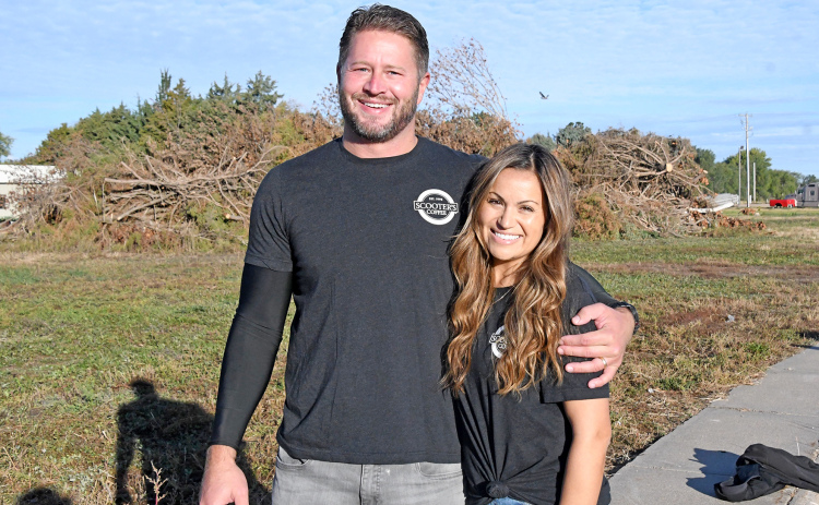Todd and Teresa Vettel stand on the Highway 34 and 5th Street site which will soon be the location of a Scooter’s Coffee. Vettel and his two brothers, Tim and Trevor, were born in Aurora and spent their early childhood years here.