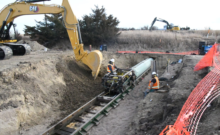 Work crews monitor massive, high-tech boring equipment used to bore holes under the roadroad tracks just off No. 4 green at Poco Creek Golf Course. The hole will now be filled with pipe as part of the city’s South Interceptor Sewer expansion project.