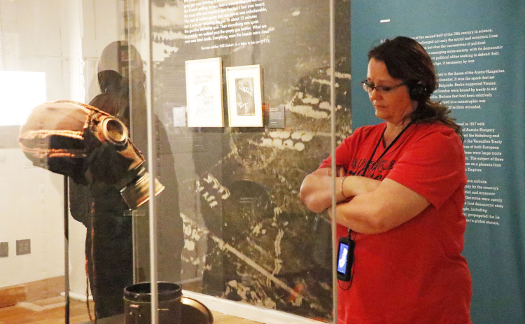 Aurora Middle School special education teacher Sally Hoos spent a quiet moment observing this gas mask while taking Friday’s tour of the Auschwitz Exhibition in Kansas City.