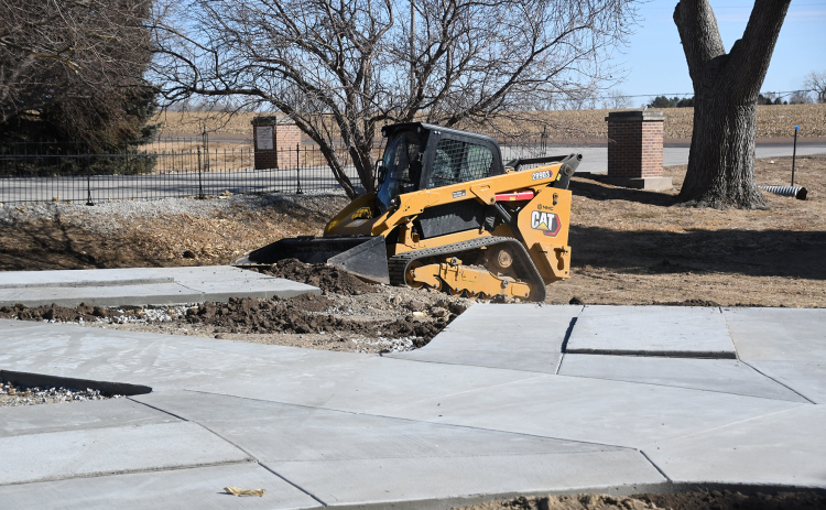 A construction worker smooths out groundwork with a compact track loader at the columbarium site in the Aurora Cemetery March 2.  Construction was started early due to the warm weather.