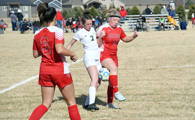 Aurora’s Addi Dummer battles for possession during a 2-0 loss to Kearney Catholic at home April 5.