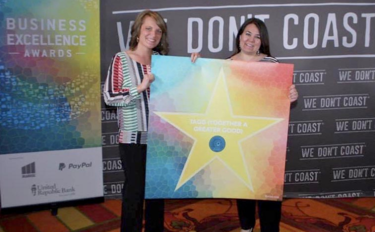 Holly Baker (left) and Leslie Fisher hold up a star with their business name, Together A Greater Good, at the 2016 Business Excellence Awards in Omaha. The business, which allows customers to donate a portion of their receipt to charitable causes, has about 10,000 active users.