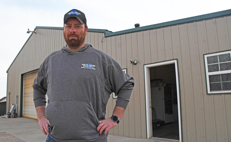 Scott Bauer stands outside his Postal Mopar workshop on the edge of town in Phillips. After eight years of being co-owner, Bauer aquired sole-ownership of the business earlier this year.