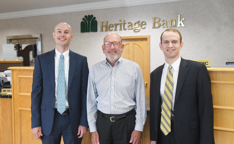 A leadership transition has been announced at Heritage Bank, with Cambell Moyer, right, succeeding his father Sam, center, as chief executive officer. Pictured at left is Jacob Arendt, the bank’s new president. Sam Moyer continues in his role as chairman of the board of Heritage Bank and chairman, CEO and president of Heritage Group, Inc., the bank’s holding company.