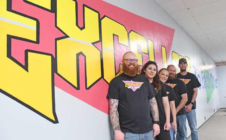 From left to right: Paul Johnson, Jen James, Mallory Johnson, Alex Hageman and Nick Lewis are the “core” team of volunteers standing next to the mural reading “Be Excellent to Each Other.”