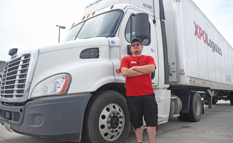 Trucker Trey Nowak stands in front of his XPO Logistics 18-wheeler before he heads out for a delivery. XPO Logistics’ less than trailer load (LTL) shipping provides flexibilty in completing orders.