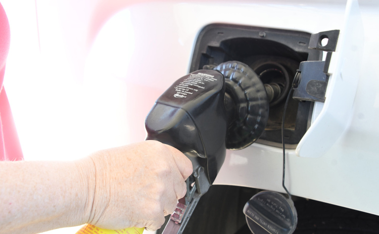 Marquette resident Kim Archer fills up her tank at the Aurora Mall. Prices at gas stations have caused her and some other residents to delay visiting family or taking vacations.