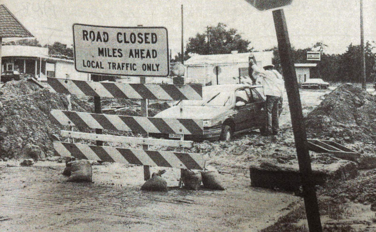 This photo taken by long-time News-Register employee Laurie Pfeifer shows Skeet Mahler’s vehicle stuck in the mud of the construction area at the 9th Street intersection of Highway 34. Originally published on June 20, 1990, similar stories were told alongside the photo of the project being plagued by rain.
