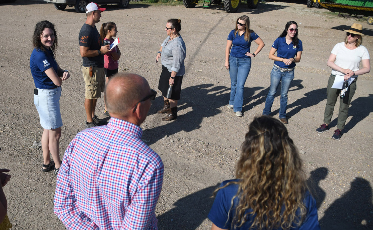 Farmer Zach Hunnicutt (third from left standing next to daughter, Adeline) discusses technology and other areas of his farm with an assembled crowd of NASA’s Earth Science Division members, UNL Extension agents and media.
