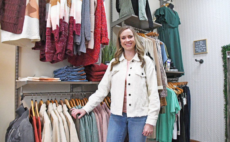 Heather Keasling, who co-owns Lilie Jack Boutique with her husband, Derek, displays some of the women’s clothing inventory in their new location.