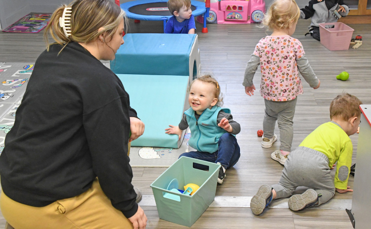 Kids, including Rylee Critel at the center, help Littler Stingers staff member Addy Petzoldt with cleanup after playtime. The Little Stingers Childcare Program now occupies two buildings to house different age groups of preschoolers.
