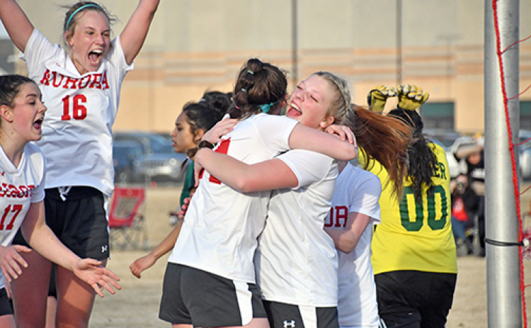 Aurora celebrates after its second goal during a 3-2 loss to Schuyler in the season-opener Monday evening.