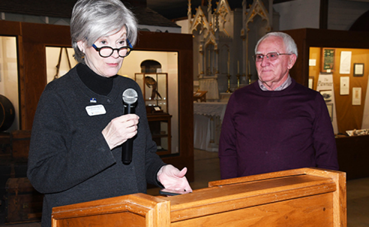 Representative of the Board of Trustees of History Nebraska Katherine Endacott delivers a presentation on volunteer Bob Cool at her right. Cool was recognized by the organization for spending 13 years and thousands of hours helping the museum in the preservation of local history.