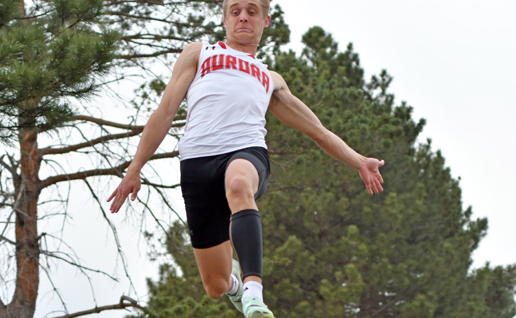 Aurora senior Carsen Staehr floats over the sand pit during one of his three long jump attempts at the Central Nebraska Track Championships Monday. Staehr earned outstanding male athlete with meet records in the long and triple jumps.