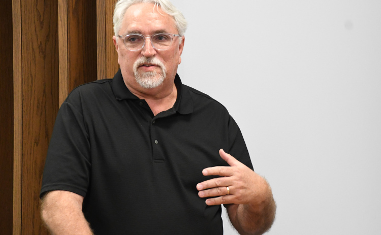Author Jeff Barnes gives a presentation of  early Nebraska history from a podium in the Alice M. Farr Library on April 18.