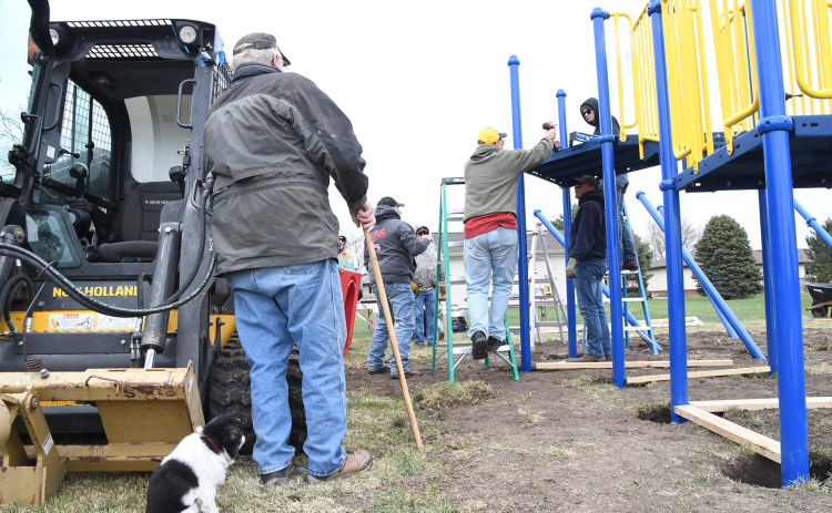 Messiah Lutheran Church volunteers, also with a supervising dog, help put together playground equipment. After more than five years and $65,000, the playground will be open to members and the wider community.