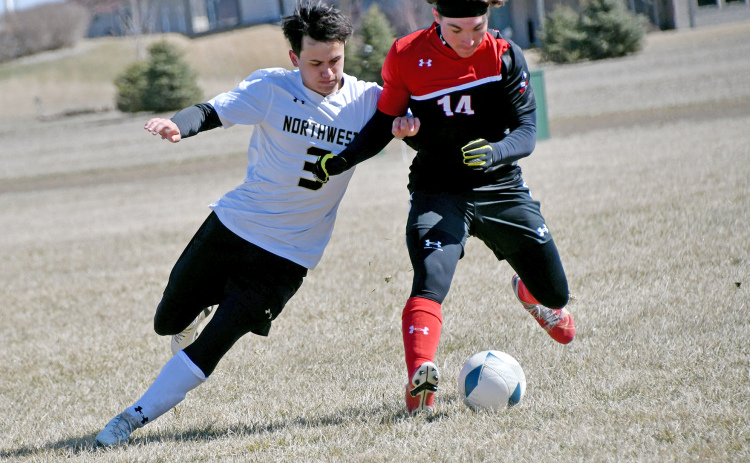 Aurora’s Keegan Chaney gets physical for possession during the Huskies’ 3-0 loss to Northwest Saturday.