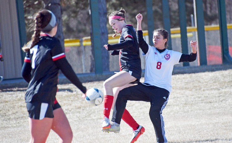 Aurora’s Aubrey Murray, who scored her first goal against Lakeview, battles for possession against Ralston.
