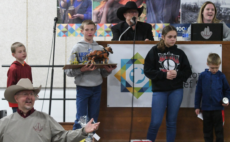 Auctioneer Kelly Kliewer, with help from several others including John Thomas out front, watches for bids during the annual MCC Auction this weekend in Aurora.