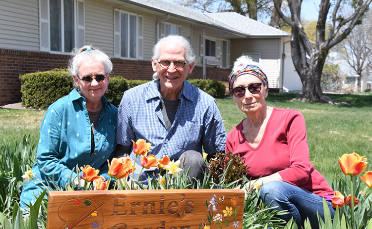 The current caretakers are seen here among the flowers of Ernie’s Garden. From left are Barbara and Britton Bailey along with the founder’s wife, Lynda Ochsner. Since artist and Alice M. Farr Library custodian Ernie Oschner passed away last fall, the Baileys have continued to take care of the garden with Lynda’s approval.