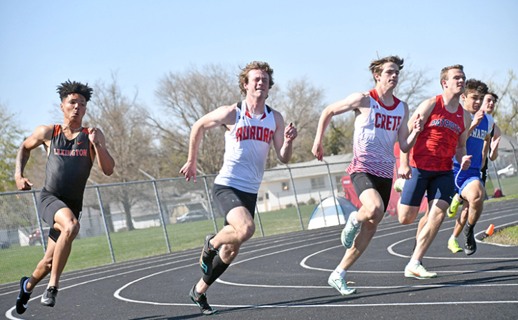 Aurora’s Koby Nachtigal (second from left) rounds the turn in the 200 meter dash finals at the Central Conference meet in Schuyler. Nachtigal finished second in the 200, just after winning the 100 dash final.