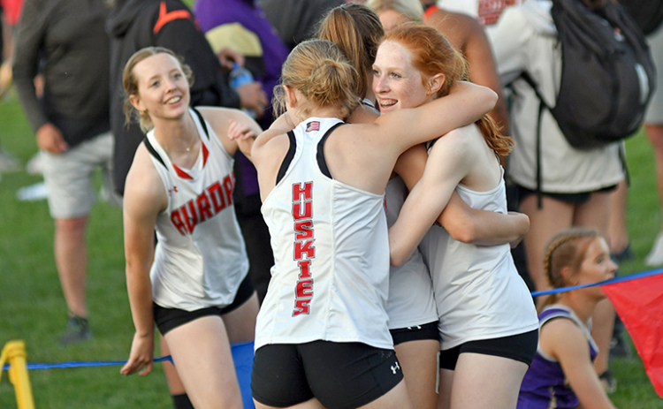 Aurora’s 1600 relay team of Adi Fahrnbruch (far left) Eva Fahrnbruch, Jordyn Slagle and Kendal Wineteer celebrate after a new PR time and second place finish.