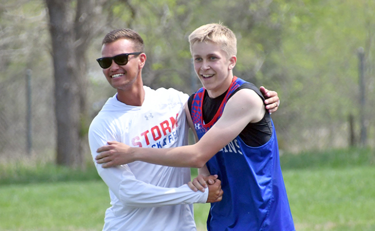 Richard Rhoden High Plains track coach Darius Williams (left) and Brodey Spurling celebrate after Spurling’s district championship in the 110 high hurdles at the D-2 district meet in Osceola.
