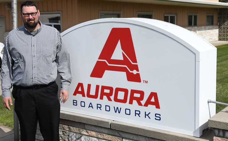 Company president and CEO Gary Bales debuts a new sign out in front of the business, which changed its name this week from International Sensor Systems Inc. to Aurora Boardworks.
