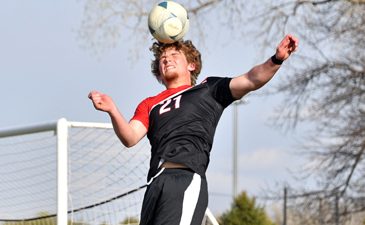 Britton Kemling reached out for a header in the offensive zone during Aurora’s 2-0 win over Holdrege Thursday.
