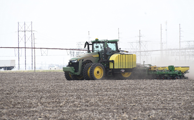A farmer uses a tractor to plant seed last week near Highway 14 north of Aurora. Four farmers from Hamilton County reported dry climate, low soil temperature and high input prices for this year’s planting season.