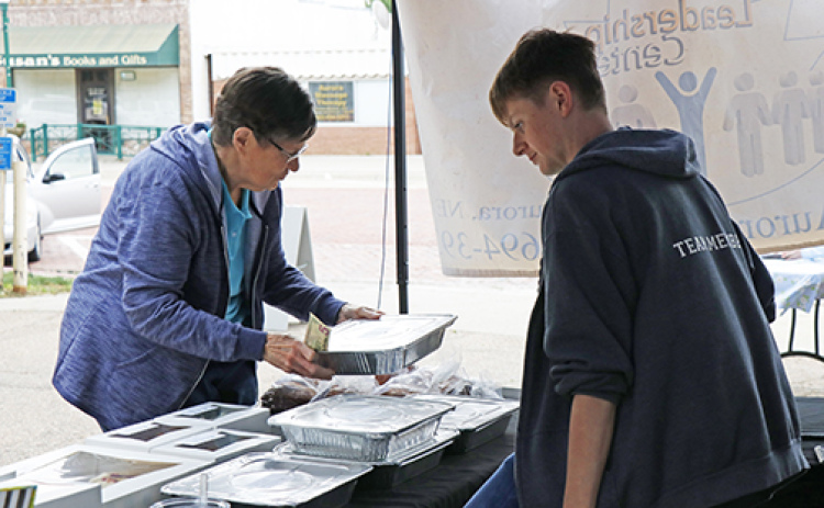 A vendor helps a customer during last year's Market on the Square, a series of Saturday events which begins this weekend.
