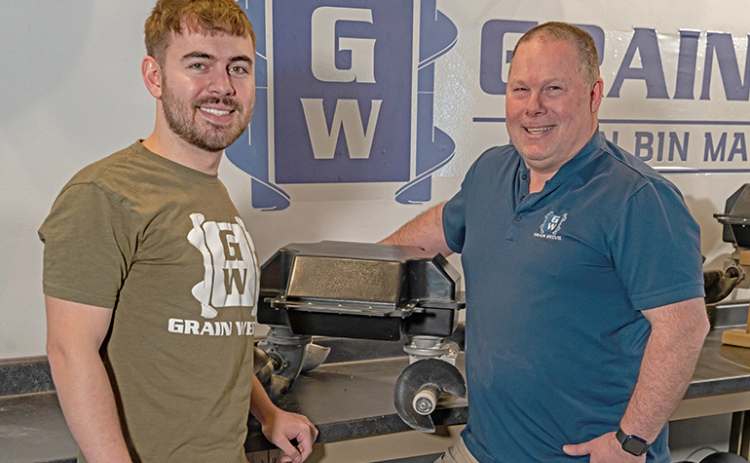 Grain Weevil co-founders, from left, Ben and Chad Johnson display the latest model of their autonomous robot that levels grain in bins and performs other tasks  to prevent grain bin deaths. The machines are currently being tested in commercial applications but the goal of the company is to make them available to family farmers by next year.