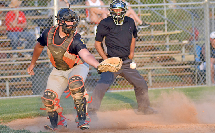 Dylan Dubas scrambles to corral the ball behind the plate during the Pinnacle Bank Seniors’ 12-11 win over Twin River last week.