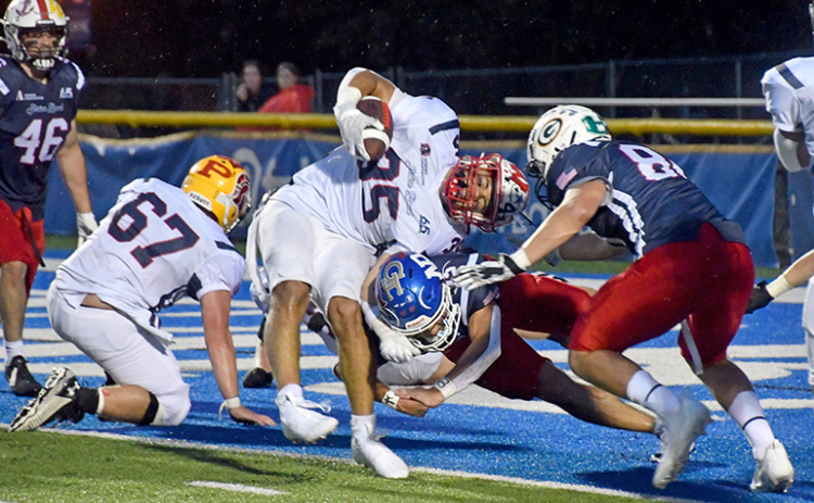 Carlos Collazo slams into North Platte’s Kolten Tilford at the goal line, breaking the plane for a touchdown in the South’s 17-7 win over the North in the 65th annual Shrine Bowl game at UNK Saturday night.