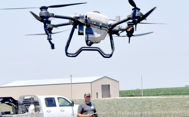 Randy Jensen at the controls of his new commercial ag drone. Jensen can apply chemical, fertilizer or seed to up to 40 acres in an hour with the drone.