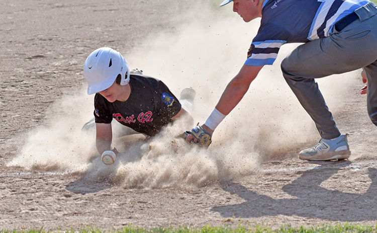 Aurora’s Keelan Phillips gets dirty into third base during a continuation game against PWG June 27.