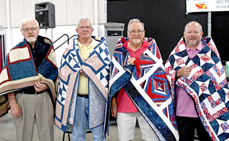 From left to right, veterans Gil Nissen, Jim Pfeifer, Jerry Chadwick and Troy Chadwick stand tall with their quilts.