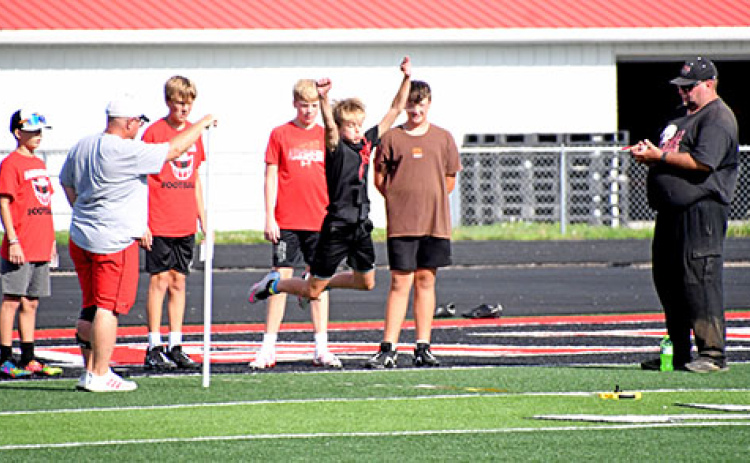 An Aurora middle schooler catches some air on Thursday at the opening of football practice.