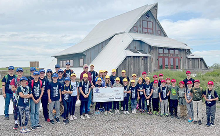 Optimist Club of Aurora presents a donation check to the campers at Summer Orientation About Rivers (SOAR).