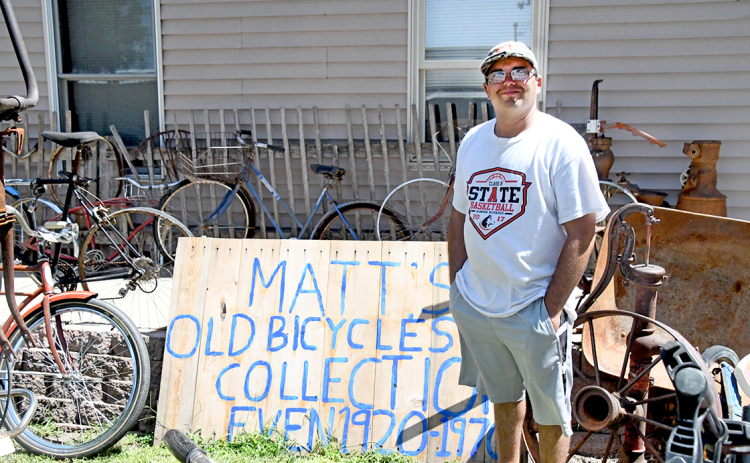 Matt Sisson stands proudly among his collected bikes that he wishes to show to the community.