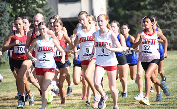 Aurora runners, from left, Ella Eggleston, Jordyn Slagle and Kendal Wineteer charge out of the gates during Thursday’s Seward Invite.