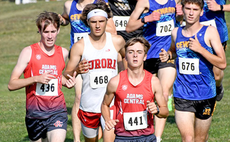 Jalen Daugherty makes a break through the pack of runners near the halfway point of the boys cross country race at the Aurora Invite on Friday.