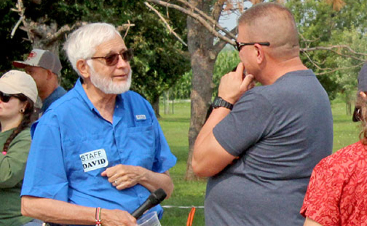 Grain Place Foods CEO David Vetter, left, visits with an attendee at the organization’s annual Field Day on July 15.