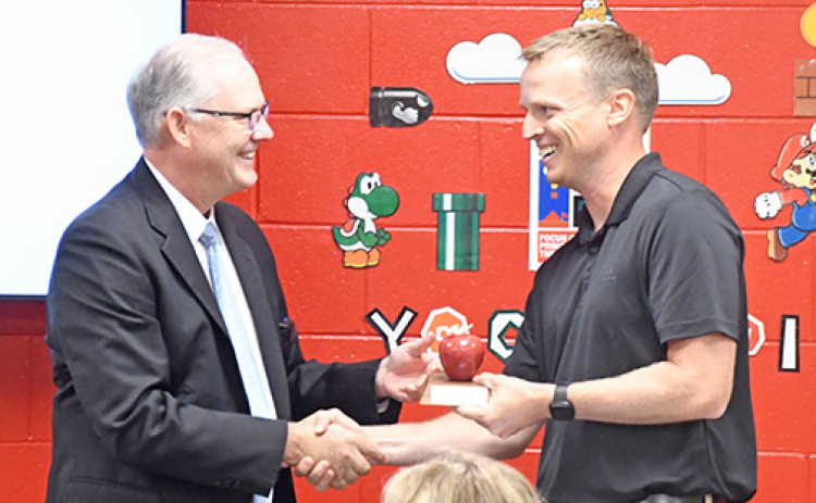 Nebraska Commissioner of Education, Brian Maher, left, presents Aurora Middle School math teacher Scott Phillips with a plaque recognizing him as 2024 Nebraska Teacher of the Year.