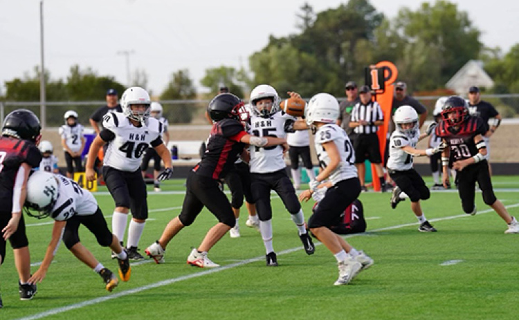 H&H players are shown in action here during the 8-man league championship game Oct. 1, which the Coyotes won 28-18.