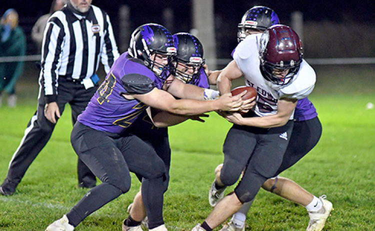 Hampton’s defense rips at the football during one of St. Edward’s fourth quarter possessions as the Hawks held on for a 48-40 win.