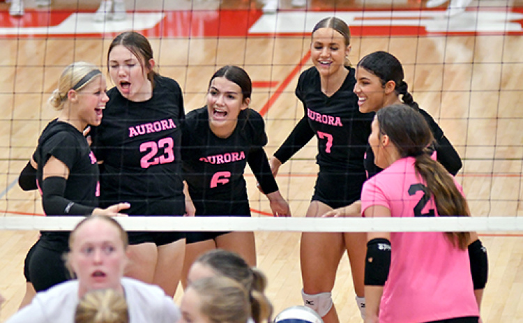 Aurora celebrates after a point during its three-set win over Lexington Sept. 26. The Huskies are set for its regular season home finale Thursday against Hastings.
