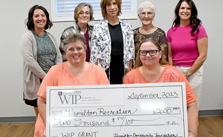 Pictured in front representing Hamilton Recreation Inc., are from left: Kathy Dyer and Tina Collingham. Women in Philanthropy members presenting the check include, back from left: Laura Reeson, Melanie Klute, Jill DeMers, Myra Higgins and Jaime Kreutz.