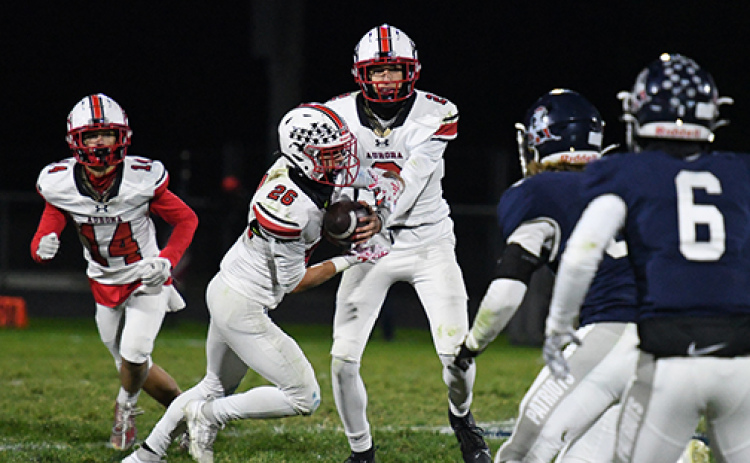 Quarterback Booker Scheierman hands off to Maddex Egger on a night where yards were hard to come by for both teams.